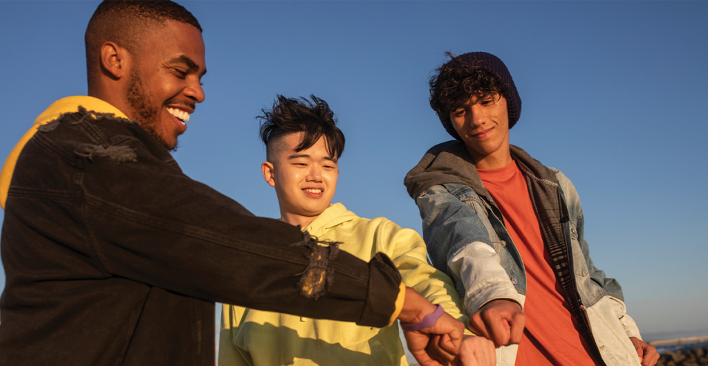 Teenage friends bumping fists.