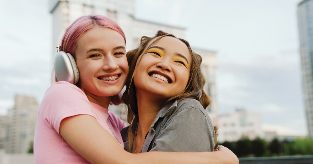 Two teens hugging.